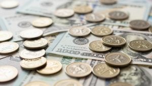Global currency banknotes and coins close-up.