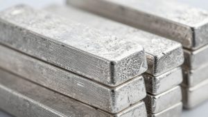 Silver bars stacked, reflecting light.