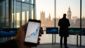 Big Ben at sunrise with a phone showing a breakout chart in the foreground
